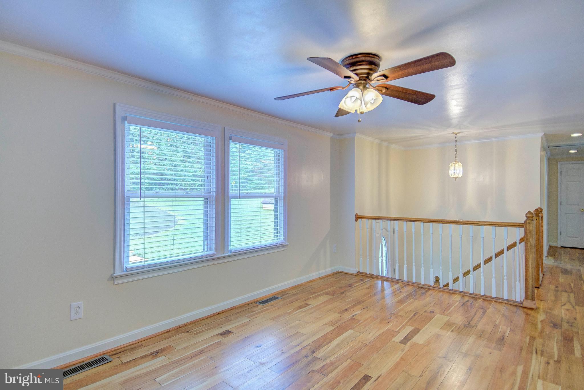 7031 Briscoe Turn Road Owings, MD 20736 - Photo 6 of 29 a view of an empty room with wooden floor and a window