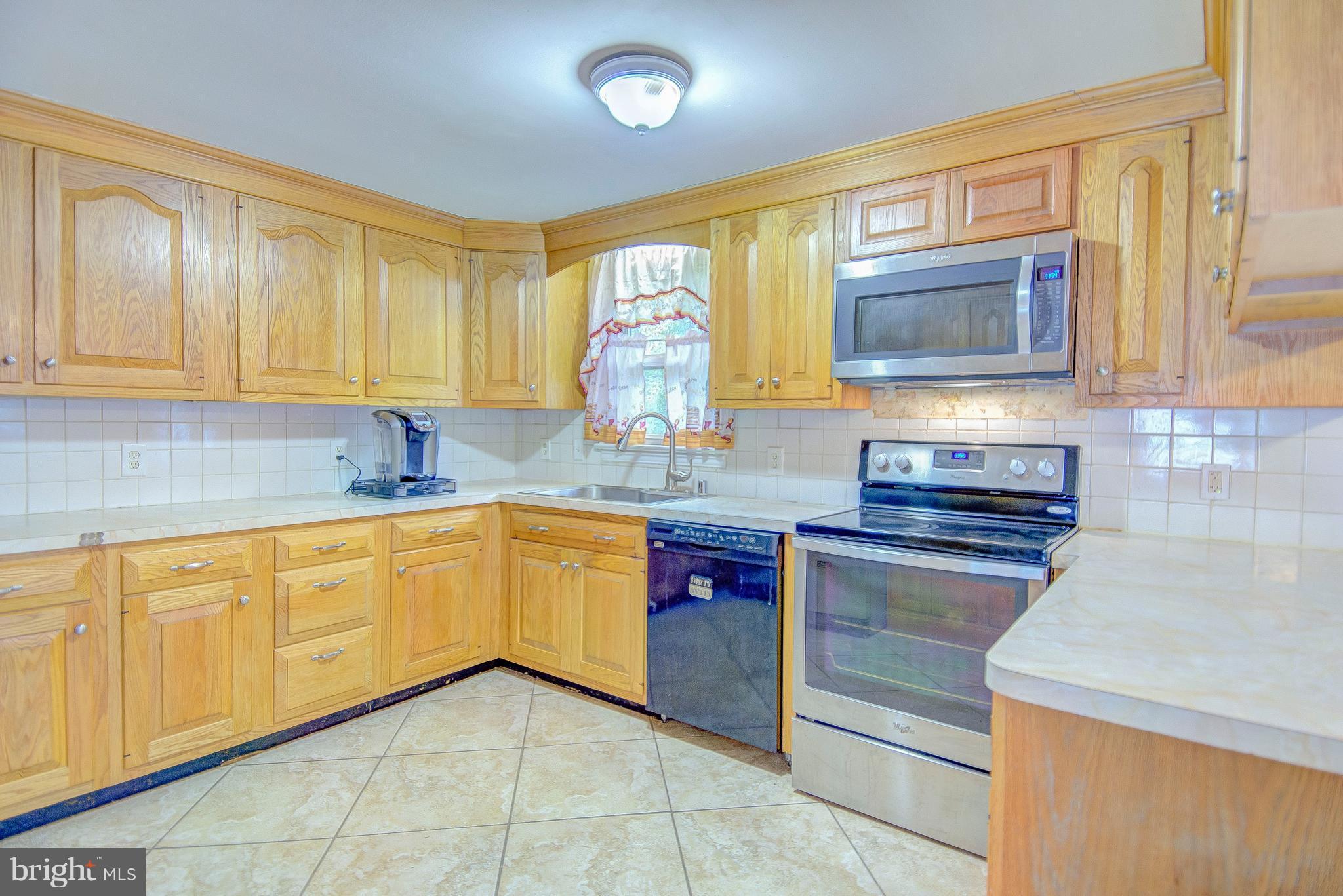 7031 Briscoe Turn Road Owings, MD 20736 - Photo 7 of 29 a kitchen with stainless steel appliances granite countertop a sink and cabinets