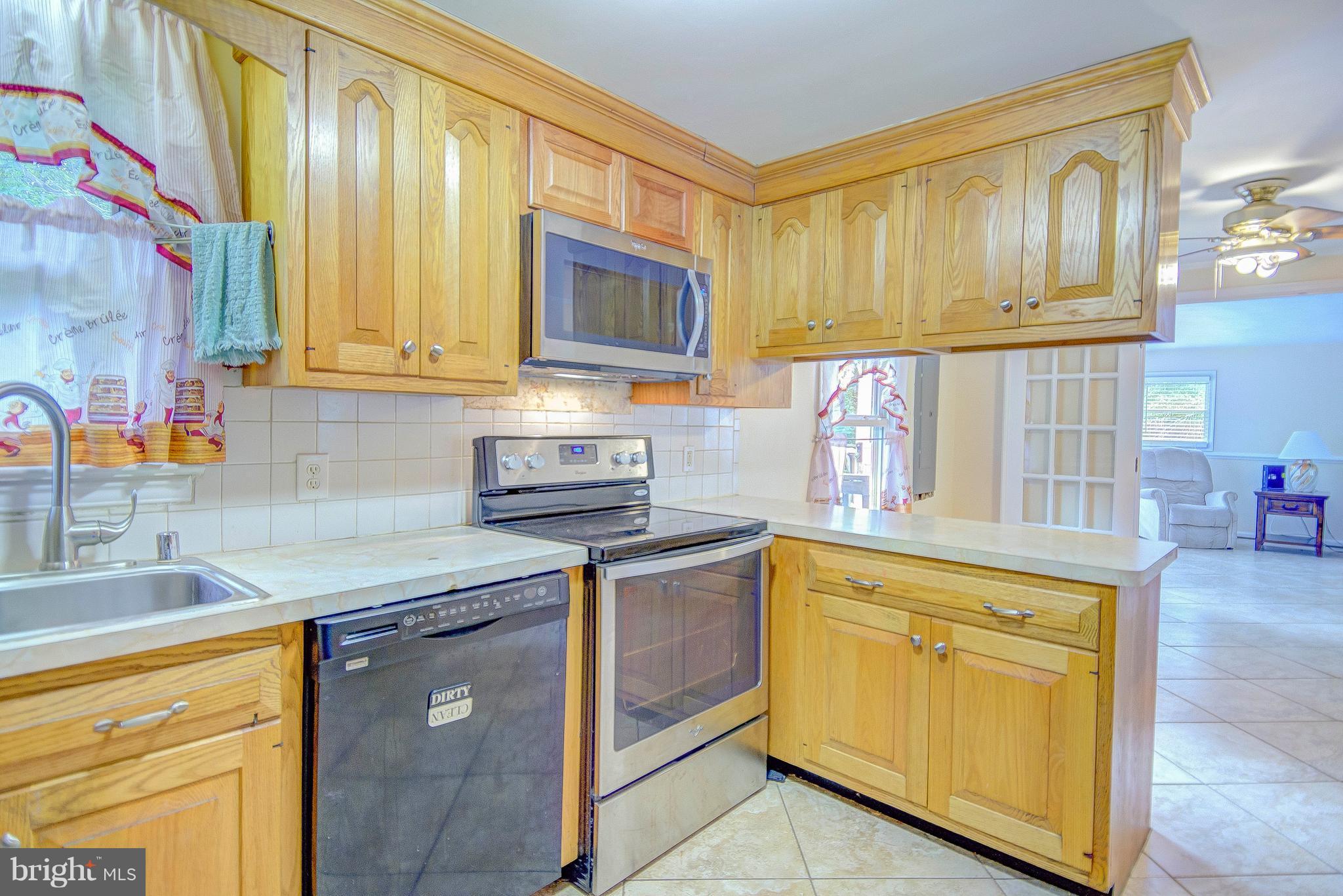 7031 Briscoe Turn Road Owings, MD 20736 - Photo 8 of 29 a kitchen with stainless steel appliances granite countertop a sink and a stove