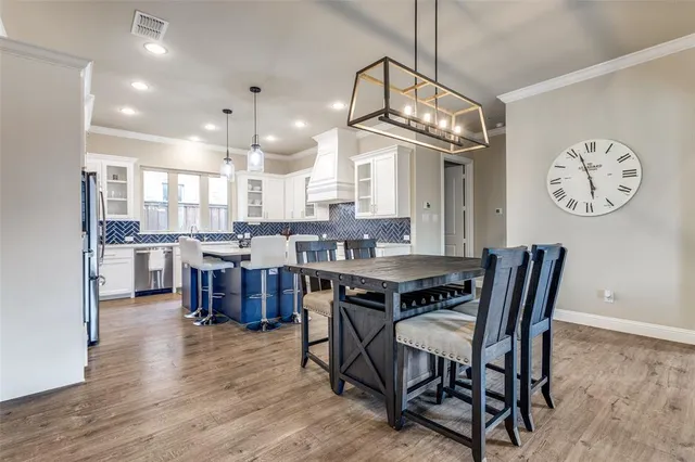 a view of a dining room with furniture and a chandelier