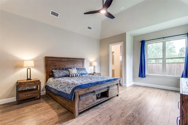 a bedroom with a bed and large window