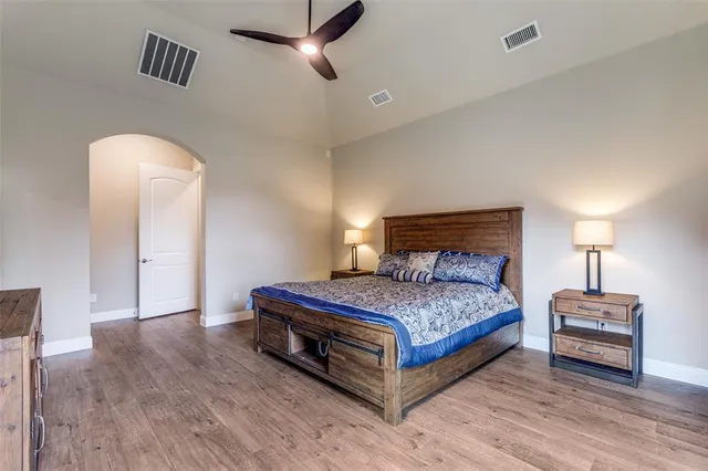 a bedroom with a bed and a lamp