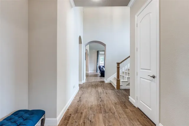 a view of a hallway view with wooden floor and staircase