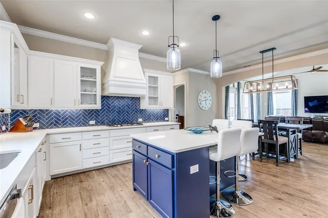 a large kitchen with a table and chairs