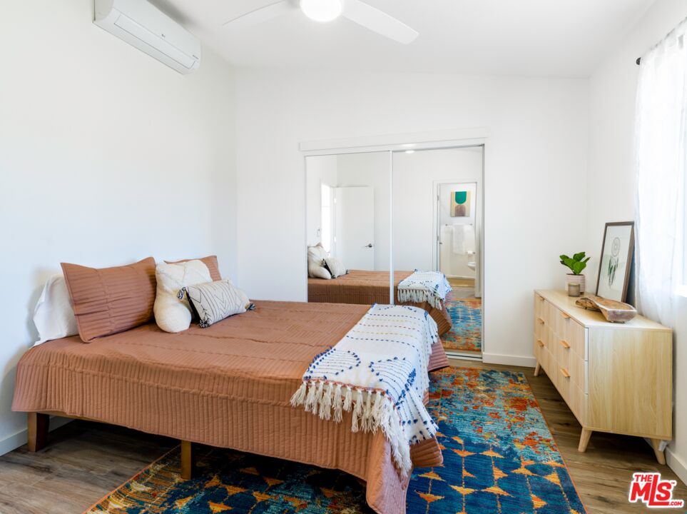 63618 2 Mile Road Joshua Tree, CA 92252 - Photo 11 of 28 a bedroom with a bed and wooden floor