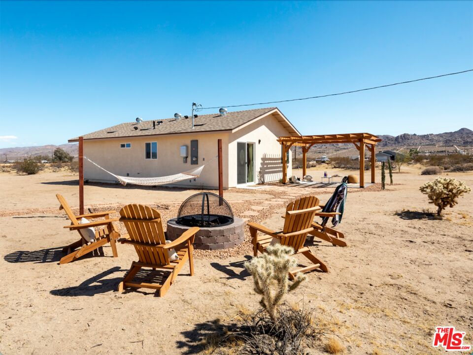 63618 2 Mile Road Joshua Tree, CA 92252 - Photo 24 of 28 a view of a terrace with chairs and barbeque grill