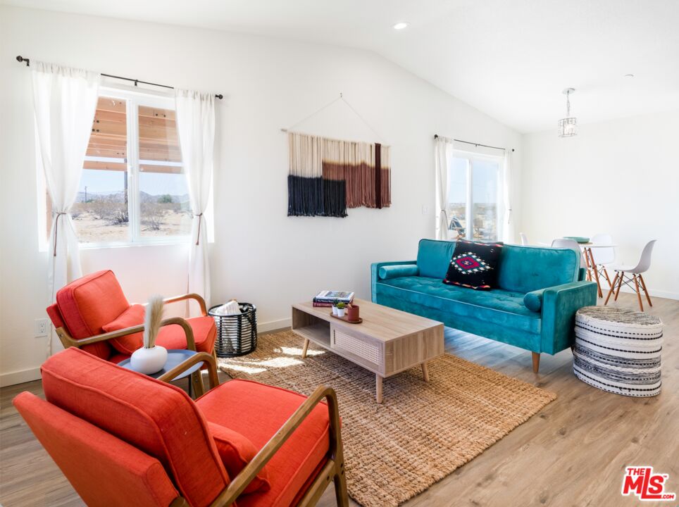 63618 2 Mile Road Joshua Tree, CA 92252 - Photo 3 of 28 a living room with furniture a rug and a window