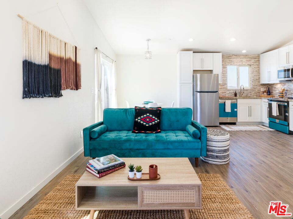 63618 2 Mile Road Joshua Tree, CA 92252 - Photo 5 of 28 a living room with kitchen island furniture and a kitchen view