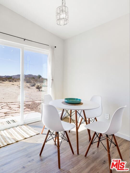 63618 2 Mile Road Joshua Tree, CA 92252 - Photo 6 of 28 a view of a dining room with furniture window and wooden floor