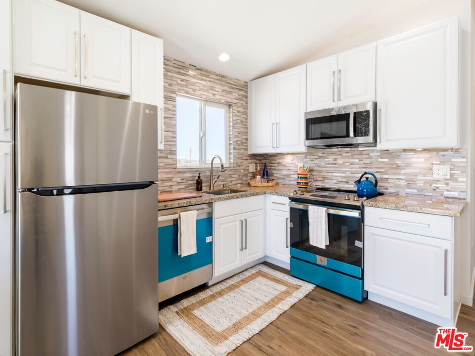 63618 2 Mile Road Joshua Tree, CA 92252 - Photo 9 of 28 a kitchen with stainless steel appliances granite countertop a refrigerator sink and microwave