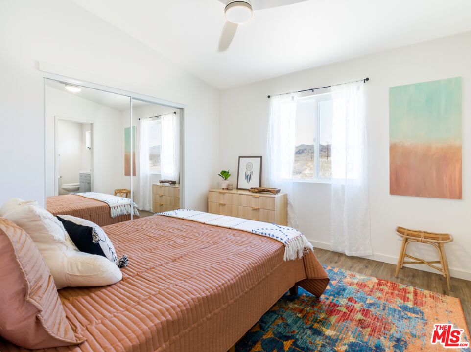 63618 2 Mile Road Joshua Tree, CA 92252 - Photo 10 of 28 a bedroom with a bed and wooden floor