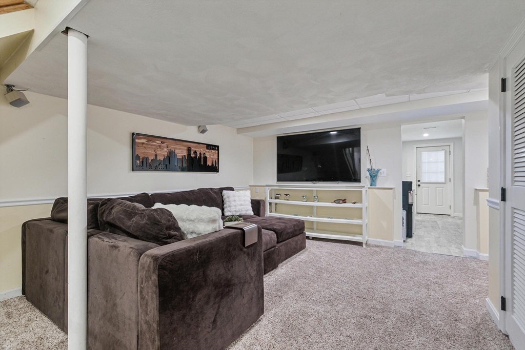 12 Cameron Way Methuen, MA 01844 - Photo 31 of 42 a living room with furniture and a flat screen tv