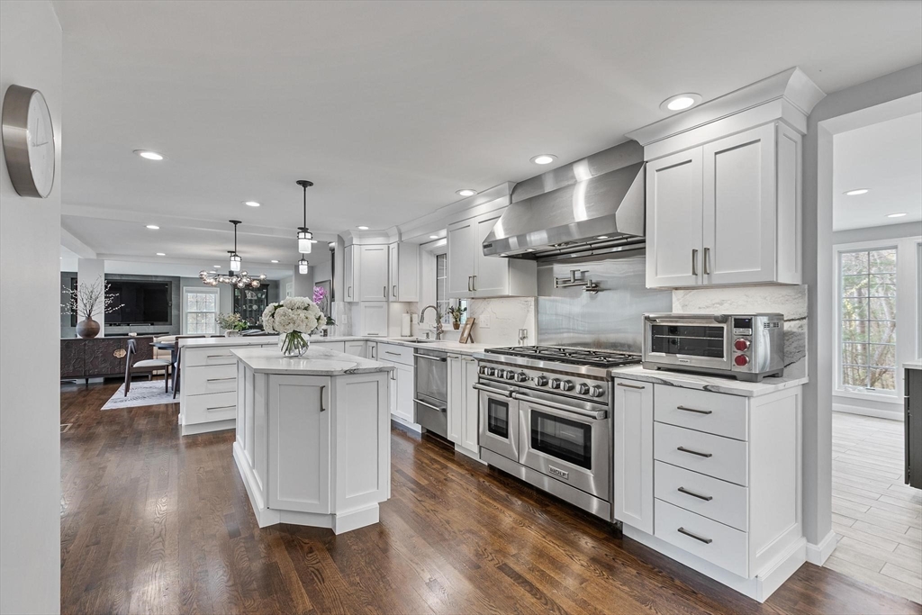 12 Cameron Way Methuen, MA 01844 - Photo 4 of 42 a kitchen with white cabinets stainless steel appliances and wooden floor