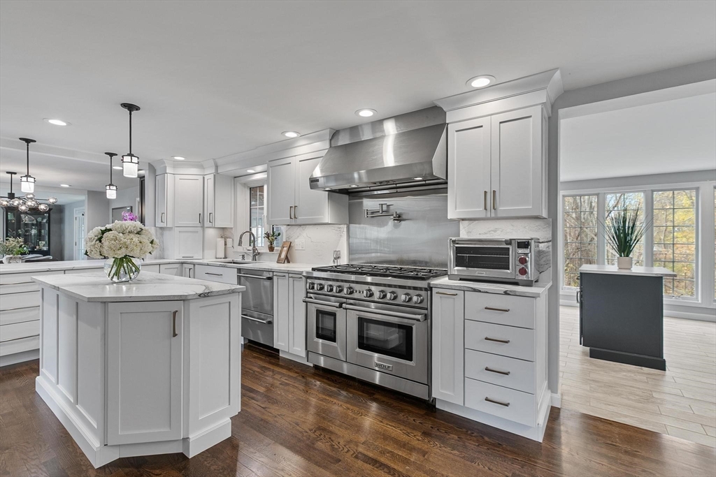 12 Cameron Way Methuen, MA 01844 - Photo 6 of 42 a kitchen with stainless steel appliances granite countertop a stove top oven a sink dishwasher and a refrigerator with wooden floor