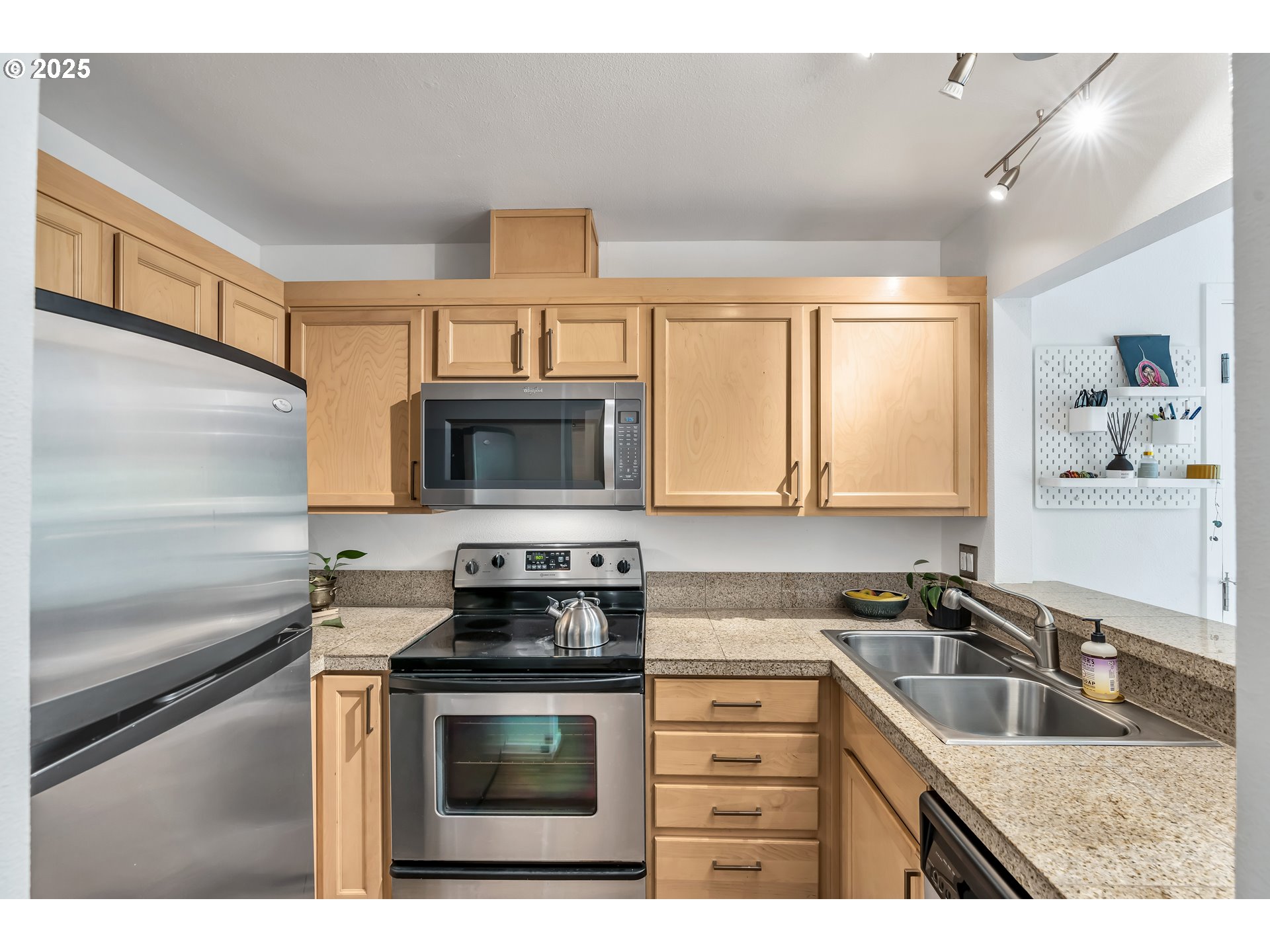 1500 Southwest Park Avenue, Unit 232 Portland, OR 97201 - Photo 15 of 40 a kitchen with stainless steel appliances granite countertop a sink stove and microwave