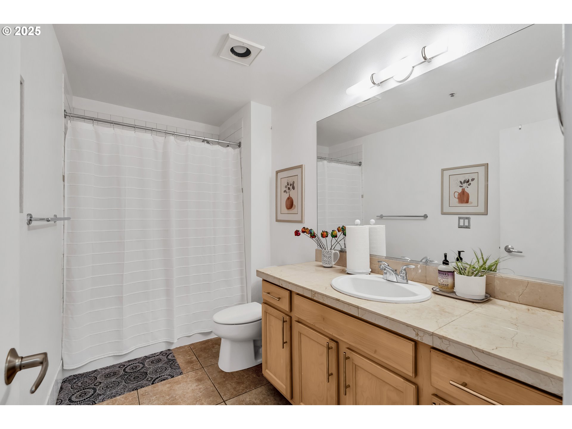 1500 Southwest Park Avenue, Unit 232 Portland, OR 97201 - Photo 18 of 40 a bathroom with a double vanity sink toilet and a mirror