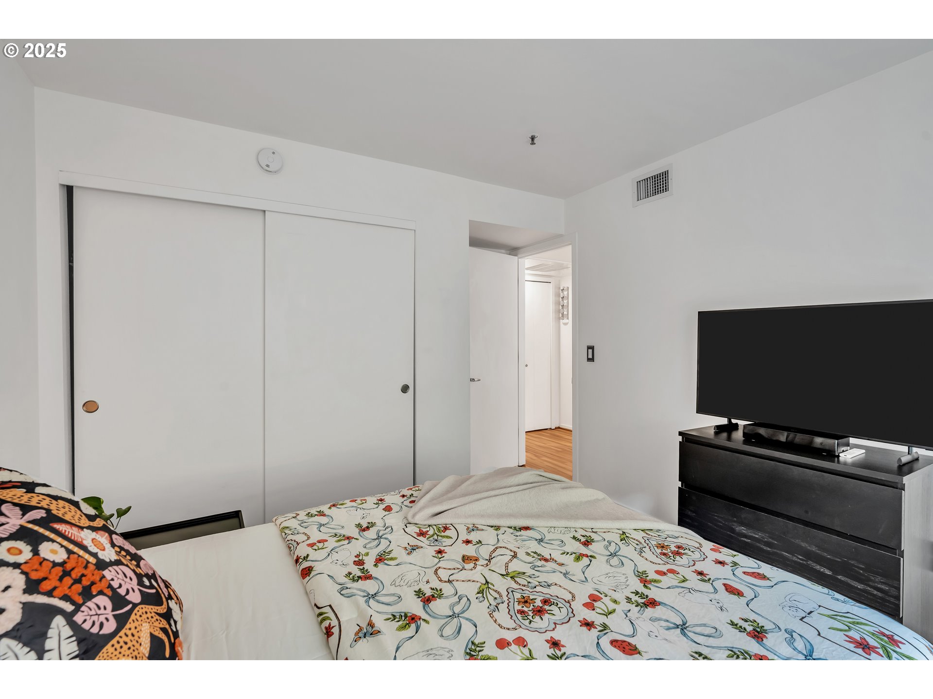 1500 Southwest Park Avenue, Unit 232 Portland, OR 97201 - Photo 19 of 40 a bedroom with a bed and a flat screen tv