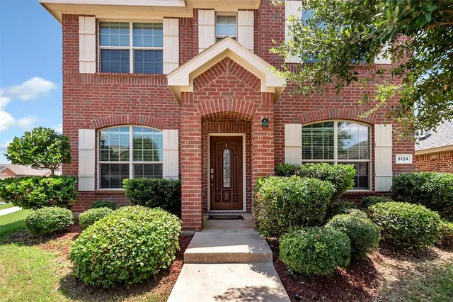 front view of a house with a garden