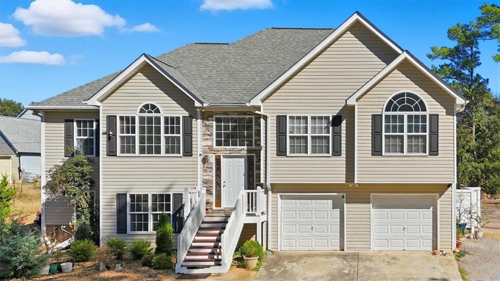 a view of a white house with large windows