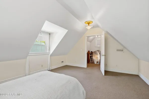 a view of a livingroom with hallway and stairs