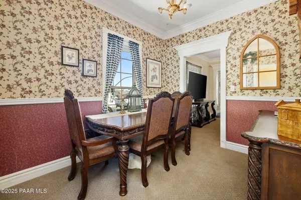 a view of a dining room with furniture and a chandelier