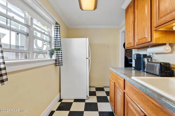 a kitchen with a refrigerator a sink and a cabinets
