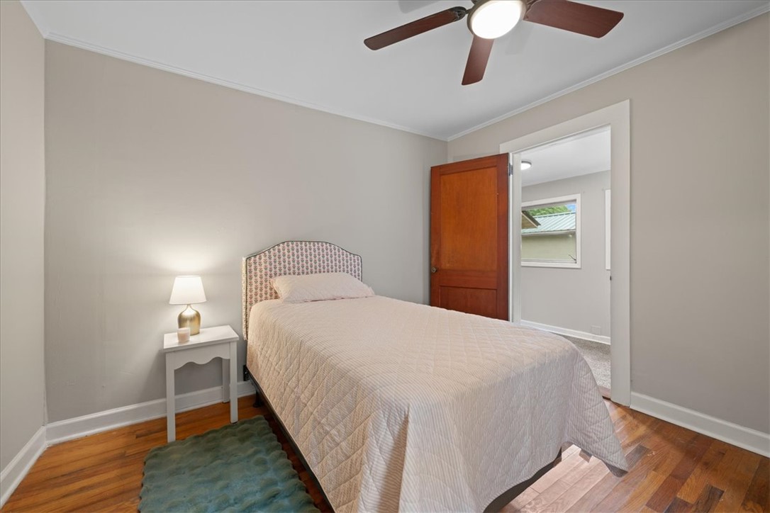 174 Holliday Road Six Mile, SC 29682 - Photo 26 of 49 Original Hardwood floors and a ceiling fan complete this cozy bedroom retreat