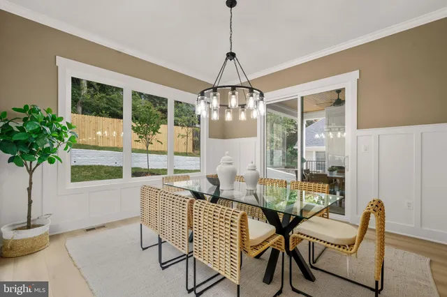 a dining room with furniture and wooden floor