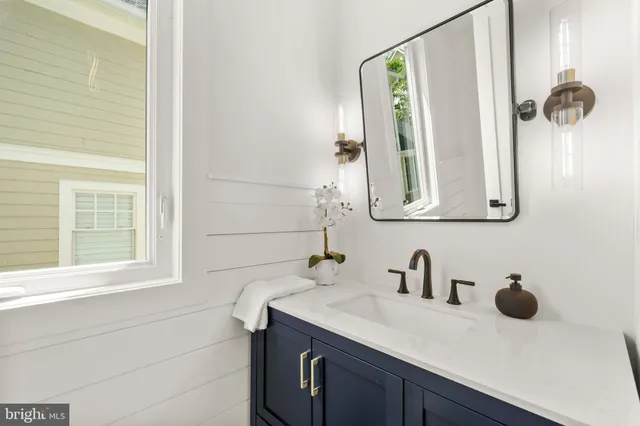 a bedroom with a bed wooden floor and window