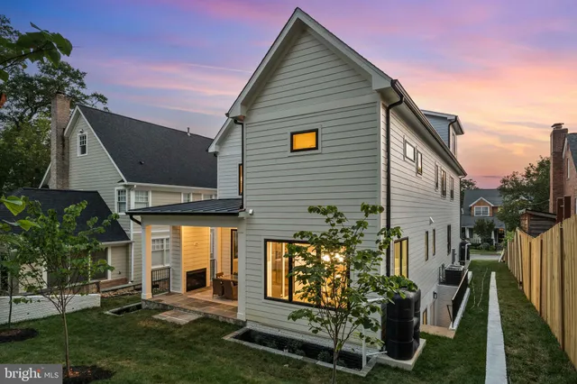 a view of house with backyard sitting area and garden
