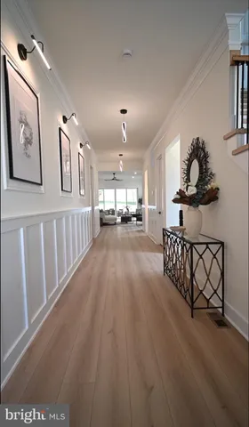 a large kitchen with kitchen island a stove a sink a refrigerator and a view of living room