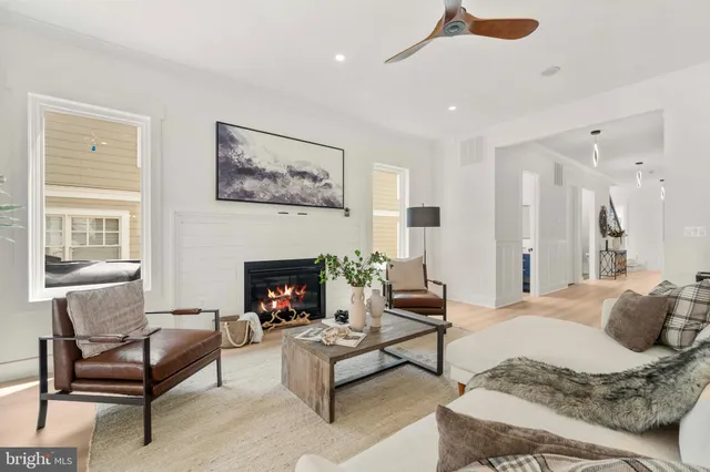 a living room with furniture large window and a fireplace
