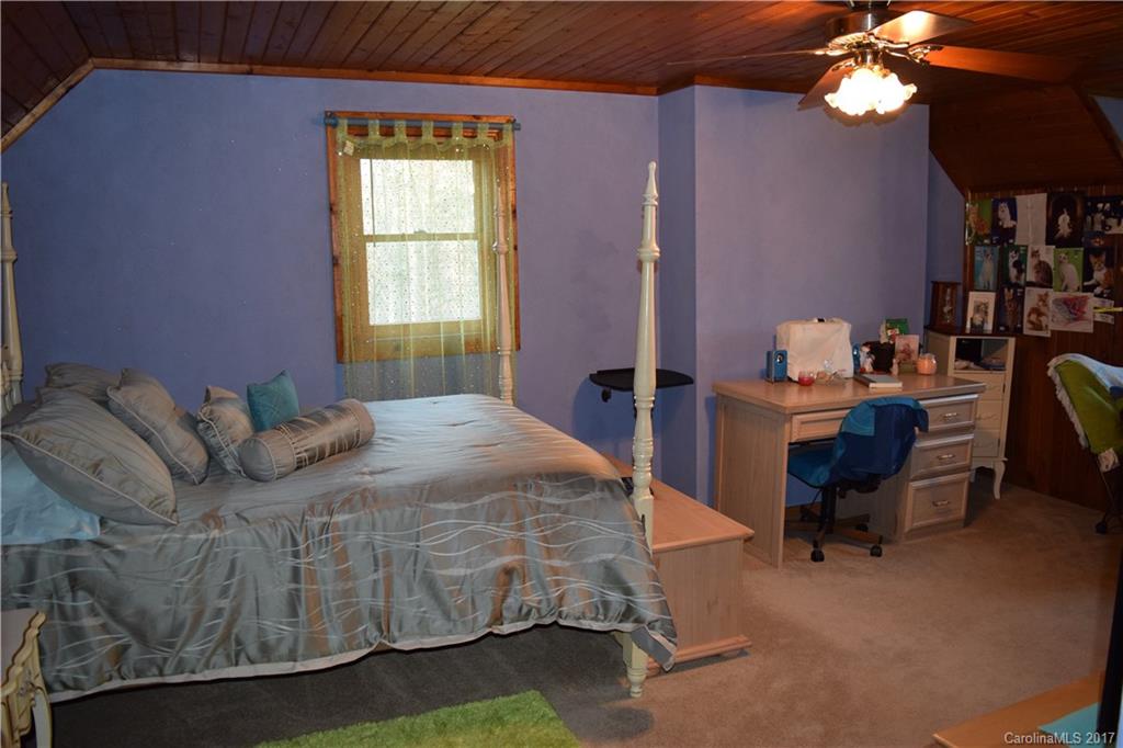 217 Day Star Ridge Clyde, NC 28721 - Photo 22 of 24 a bedroom with a bed window and a chair