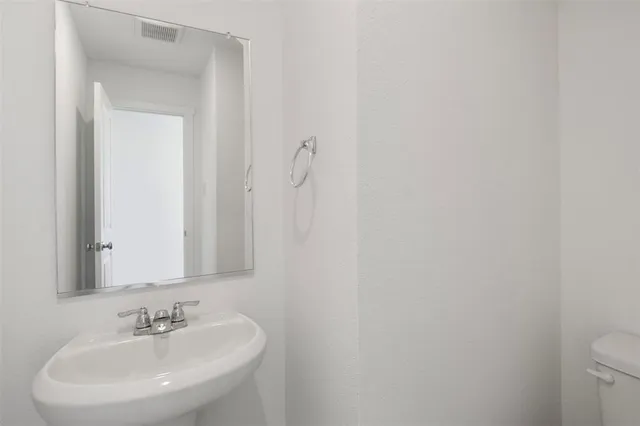 a kitchen with granite countertop white cabinets and stainless steel appliances