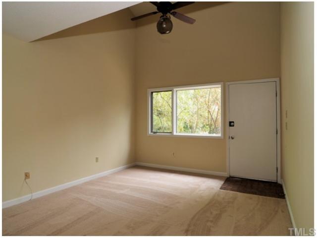 4300 Hunters Club Drive Raleigh, NC 27606 - Photo 3 of 19 Living Room with Ceiling Fan and Huge Window will let the Sunshine in! New Paint and Carpet through out!
