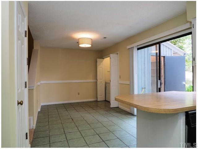 4300 Hunters Club Drive Raleigh, NC 27606 - Photo 6 of 19 Eat-in Kitchen with Breakfast Bar! Laundry off Kitchen, Washer and Dryer stay, Storage off the patio! New Light fixture!