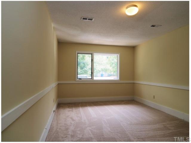 4300 Hunters Club Drive Raleigh, NC 27606 - Photo 8 of 19 Another view of the large 1st Floor Bedroom! New Paint and Carpet through out!