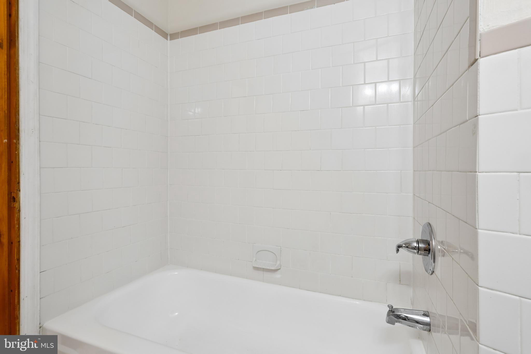 147 Denison Street Baltimore, MD 21229 - Photo 14 of 21 a bathroom with a white bath tub