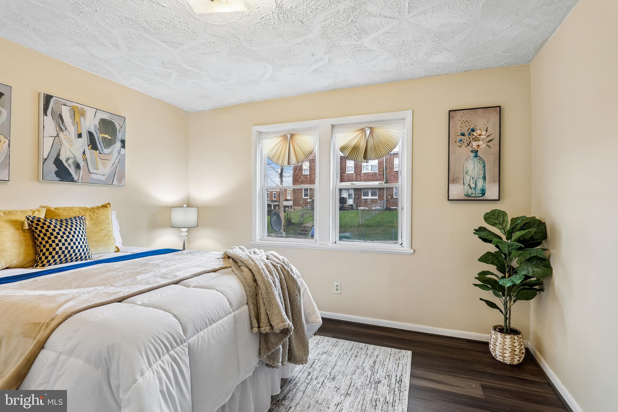 147 Denison Street Baltimore, MD 21229 - Photo 18 of 21 a bed sitting in a bedroom next to a window