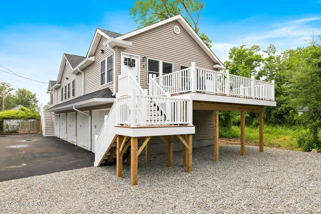 a white house that has a table and chairs in it