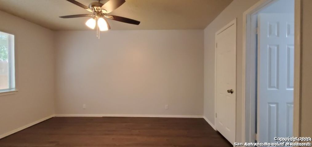5236 Meadow Rise Street San Antonio, TX 78250 - Photo 12 of 25 an empty room with wooden floor closet and fan