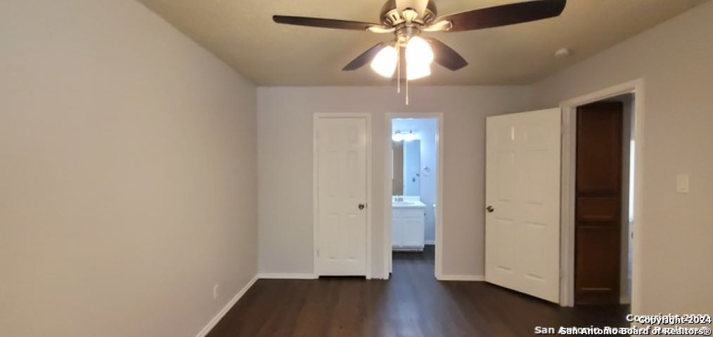 5236 Meadow Rise Street San Antonio, TX 78250 - Photo 13 of 25 wooden floor in an empty room with a window