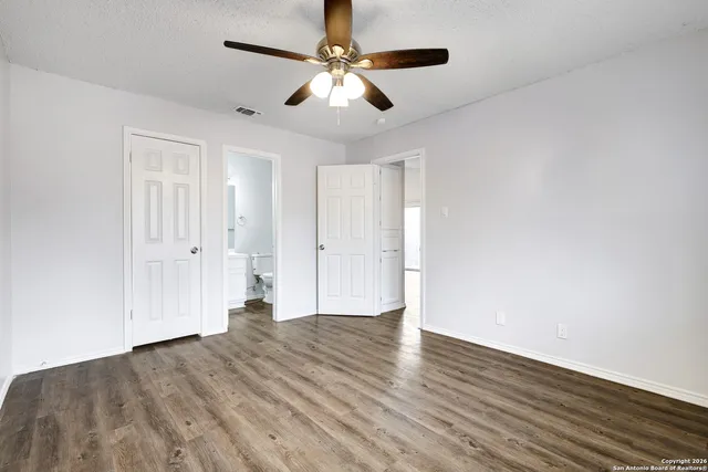 a view of empty room with wooden floor