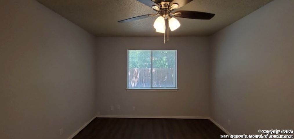 5236 Meadow Rise Street San Antonio, TX 78250 - Photo 14 of 25 an empty room with a window and a fan