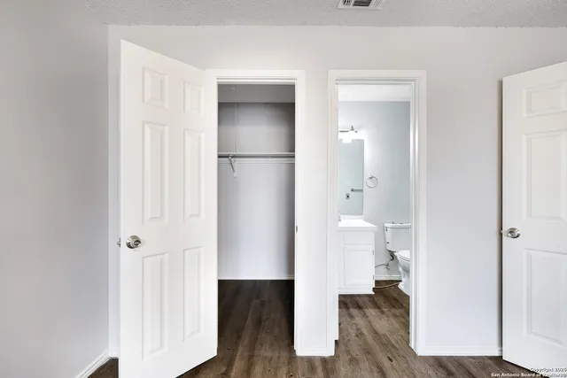 a view of bathroom with a toilet a sink and a mirror
