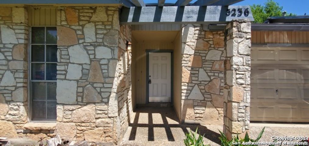 5236 Meadow Rise Street San Antonio, TX 78250 - Photo 2 of 25 a view of a wooden door with a bench