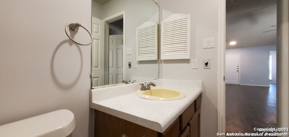 5236 Meadow Rise Street San Antonio, TX 78250 - Photo 21 of 25 a bathroom with a sink a toilet and a mirror