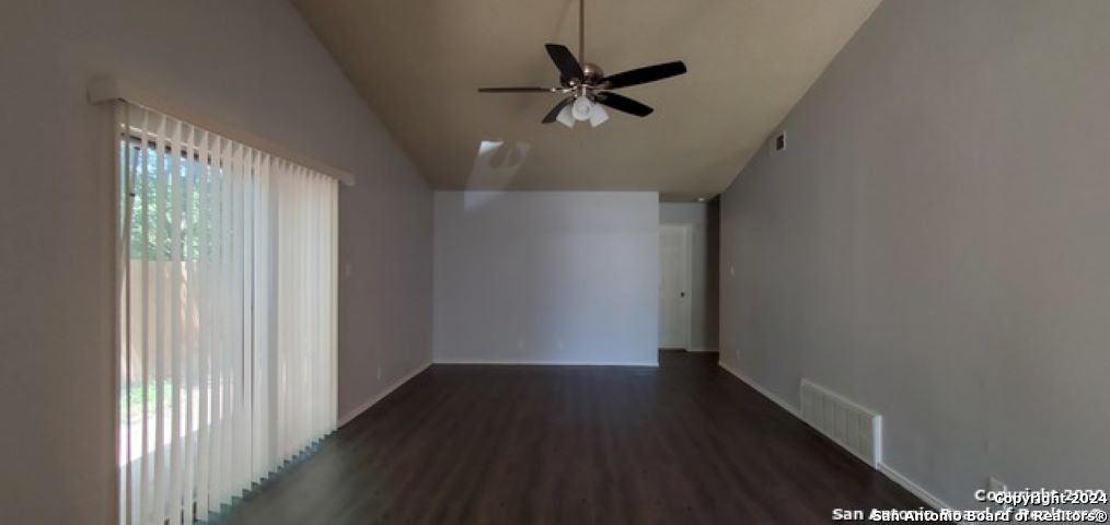 5236 Meadow Rise Street San Antonio, TX 78250 - Photo 5 of 25 a view of a hallway with wooden floor and a ceiling fan