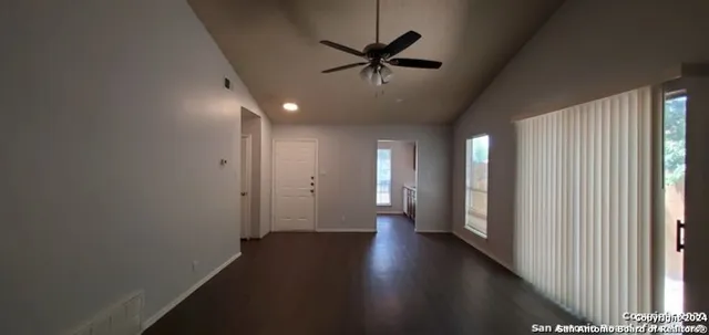 a view of an empty room with a ceiling fan