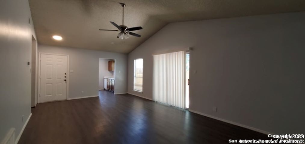 5236 Meadow Rise Street San Antonio, TX 78250 - Photo 8 of 25 a view of an empty room with a window and wooden floor